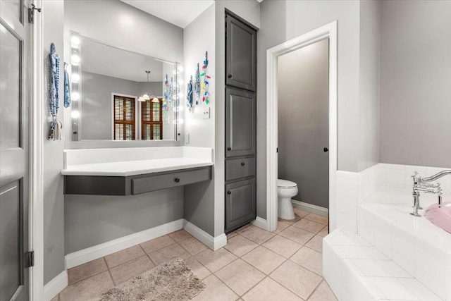 full bath featuring tile patterned floors, baseboards, a garden tub, and toilet