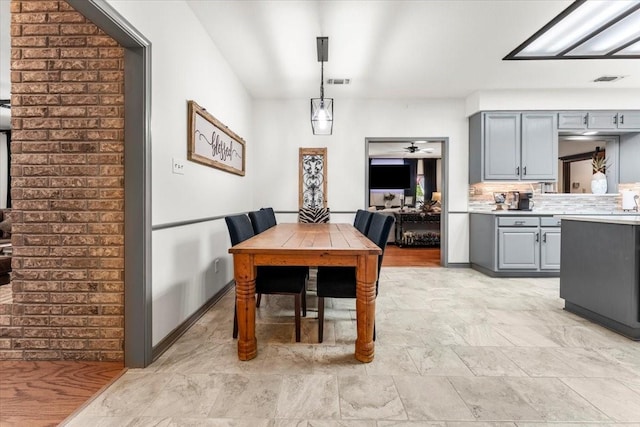 dining area with a ceiling fan and visible vents