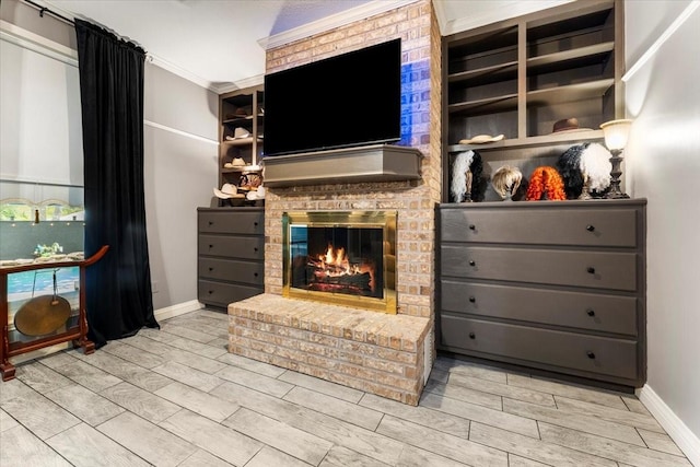 living area with a brick fireplace, wood finish floors, and baseboards