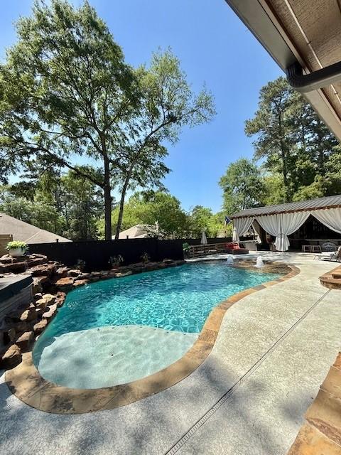 view of swimming pool featuring a fenced in pool, a patio, and a fenced backyard