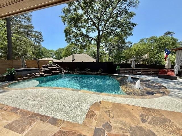 view of swimming pool featuring a patio, a fenced backyard, a jacuzzi, and a fenced in pool