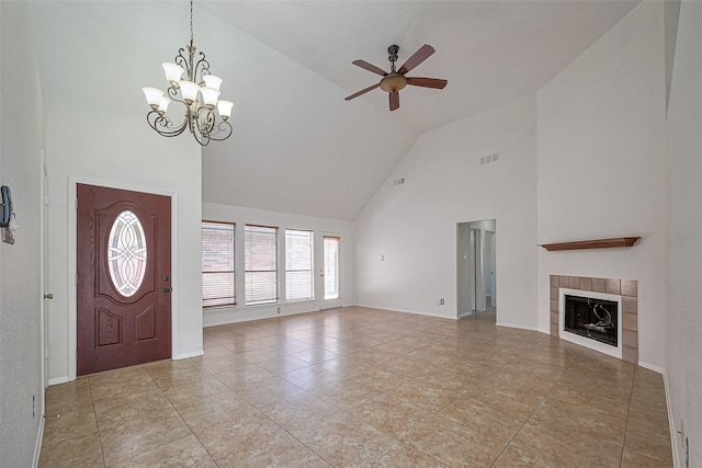 13322 Chaston Dr, Houston, TX 77041 - foyer entrance with high vaulted ceiling, ceiling fan, a fireplace, a chandelier, and baseboards