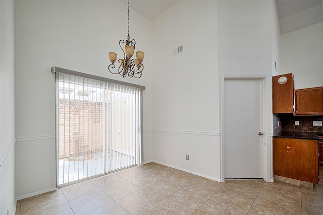 13322 Chaston Dr, Houston, TX 77041 - unfurnished dining area featuring high vaulted ceiling, plenty of natural light, a chandelier, baseboards, and light tile patterned floors