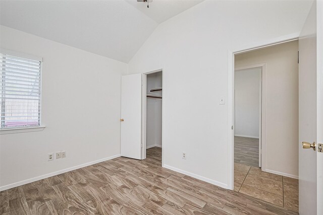 13322 Chaston Dr, Houston, TX 77041 - unfurnished bedroom with lofted ceiling, a closet, and baseboards
