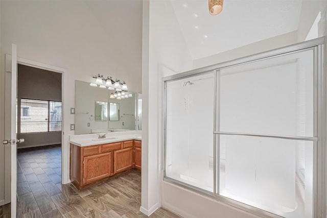 13322 Chaston Dr, Houston, TX 77041 - bathroom with vanity, high vaulted ceiling, wood finished floors, baseboards, and enclosed tub / shower combo