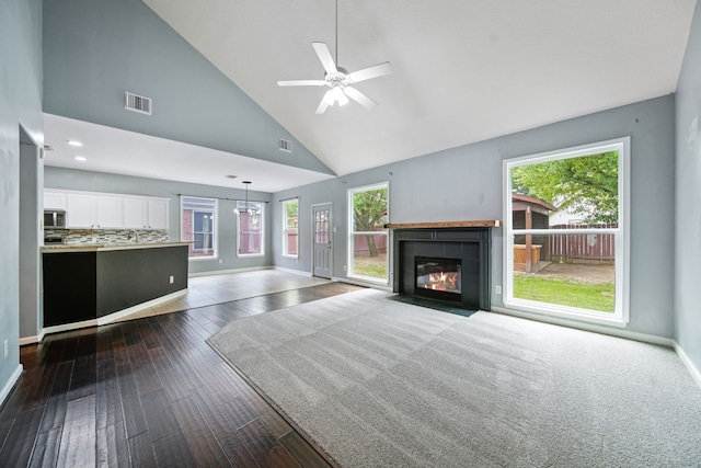 14507 Heron Marsh Dr, Cypress, TX 77429 - unfurnished living room featuring high vaulted ceiling, a fireplace, dark wood-type flooring, a ceiling fan, and baseboards