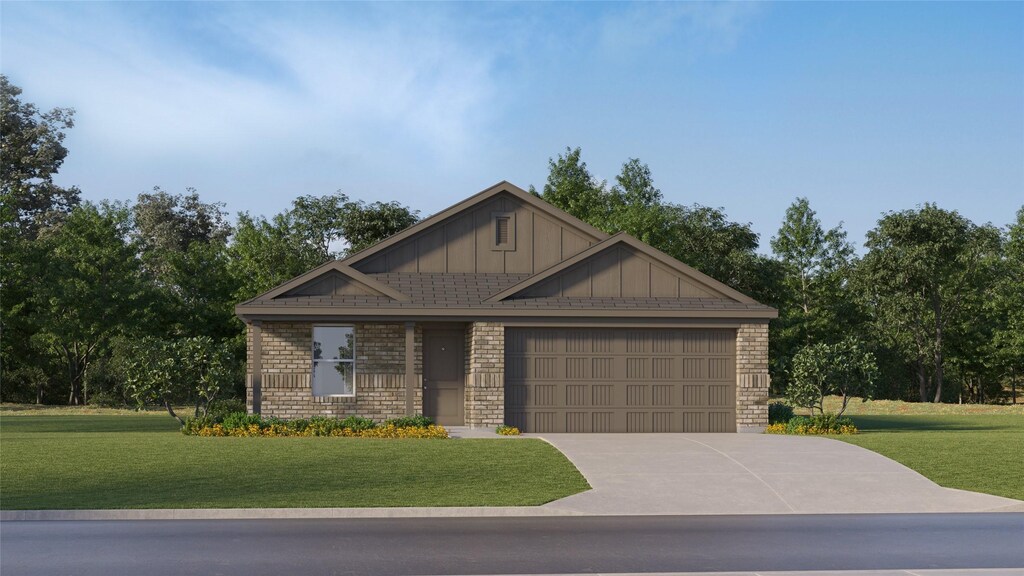 craftsman-style house featuring board and batten siding, brick siding, a front yard, and an attached garage