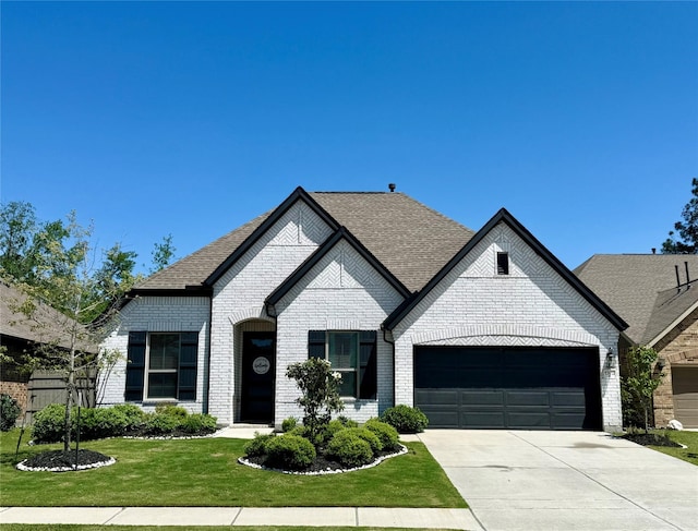 17413 Chestnut Cove Dr, Conroe, TX 77302 - view of front of home with concrete driveway, brick siding, a garage, a shingled roof, and a front yard