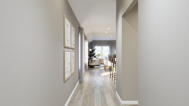 hallway with light wood-style flooring, baseboards, and recessed lighting