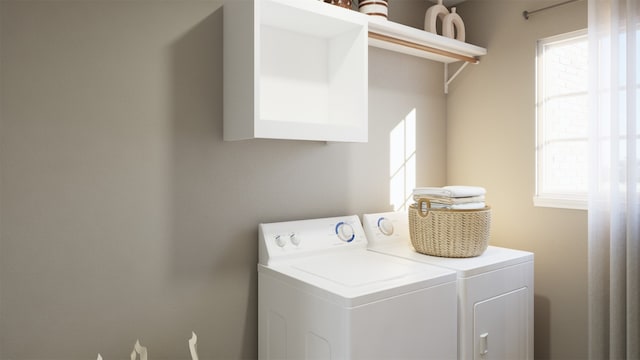clothes washing area featuring washing machine and clothes dryer and laundry area