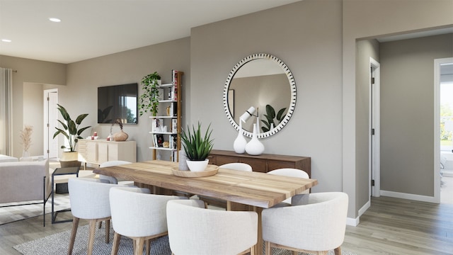 dining room with baseboards, wood finished floors, and recessed lighting