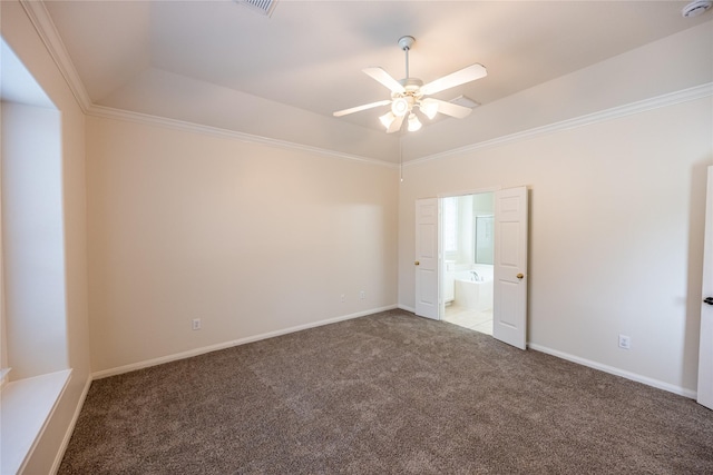 unfurnished bedroom featuring ensuite bathroom, crown molding, visible vents, a raised ceiling, and carpet