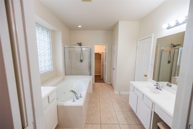 bathroom featuring a tub with jets, a walk in closet, a shower stall, vanity, and tile patterned floors