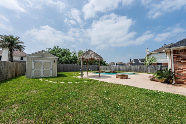 view of yard with a fenced in pool, a patio area, a fenced backyard, a storage shed, and a gazebo