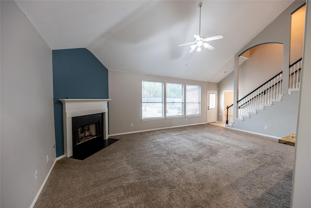 unfurnished living room featuring a fireplace, baseboards, a ceiling fan, and carpet floors