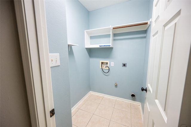 washroom featuring light tile patterned floors, washer hookup, hookup for a gas dryer, laundry area, and hookup for an electric dryer