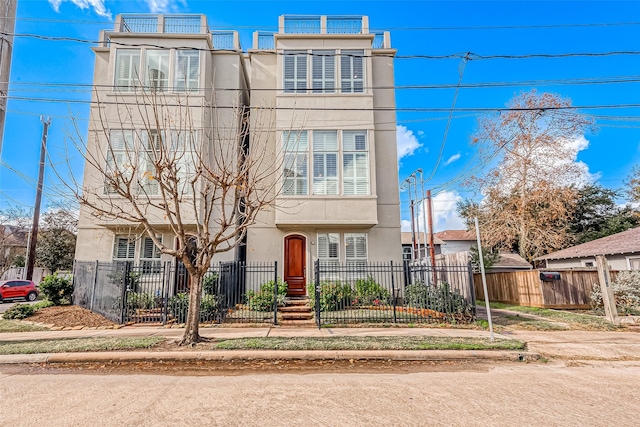 1804 Haddon St, Houston, TX 77019 - view of front of property featuring stucco siding and a fenced front yard