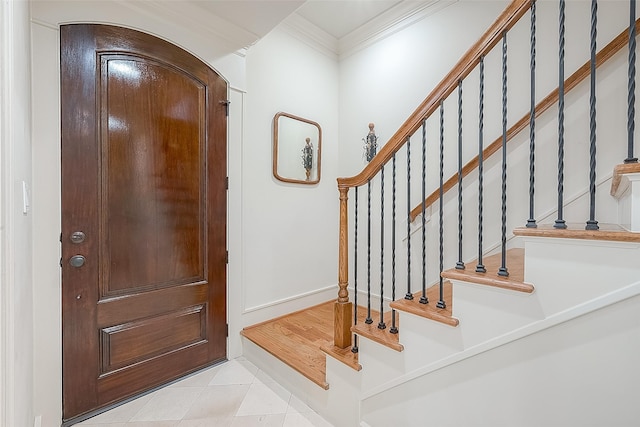 1804 Haddon St, Houston, TX 77019 - foyer entrance featuring ornamental molding, light tile patterned floors, stairs, and arched walkways