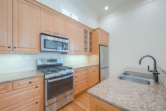 1804 Haddon St, Houston, TX 77019 - kitchen with appliances with stainless steel finishes, a sink, light brown cabinets, and crown molding
