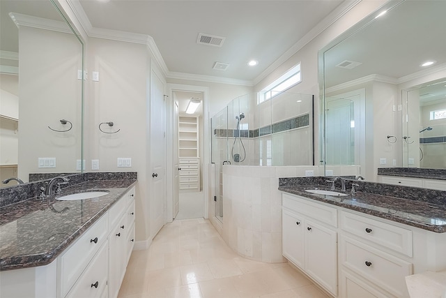 1804 Haddon St, Houston, TX 77019 - full bathroom featuring a shower stall, a walk in closet, two vanities, crown molding, and recessed lighting