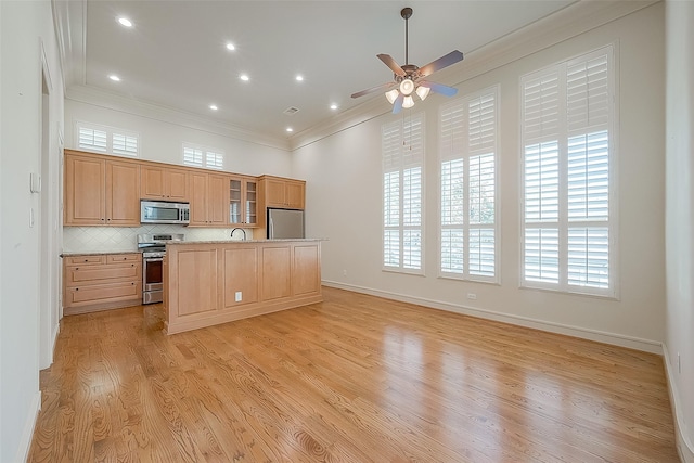 1804 Haddon St, Houston, TX 77019 - kitchen with appliances with stainless steel finishes, crown molding, a ceiling fan, an island with sink, and decorative backsplash