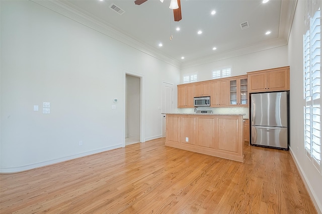1804 Haddon St, Houston, TX 77019 - kitchen featuring stainless steel appliances, light wood-type flooring, crown molding, decorative backsplash, and a kitchen island with sink