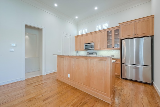 1804 Haddon St, Houston, TX 77019 - kitchen with stainless steel appliances, light brown cabinets, light wood-type flooring, crown molding, and a center island