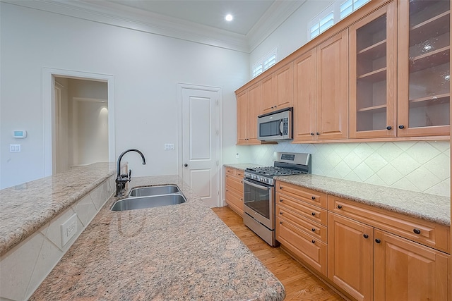 1804 Haddon St, Houston, TX 77019 - kitchen with stainless steel appliances, a sink, ornamental molding, light wood-type flooring, and decorative backsplash