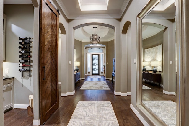 5111 Water Oak Cres, Fulshear, TX 77441 - entrance foyer featuring crown molding, arched walkways, and dark wood-type flooring