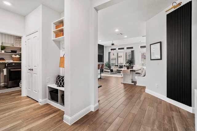 hall with recessed lighting, baseboards, and wood finished floors