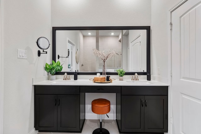full bathroom featuring double vanity, a sink, and tile patterned floors