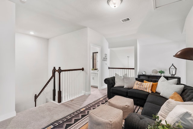 living room with light carpet, baseboards, and visible vents