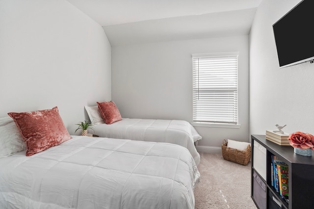 carpeted bedroom with baseboards and vaulted ceiling