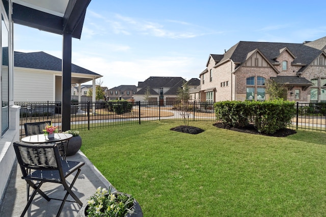 view of yard with a residential view and fence