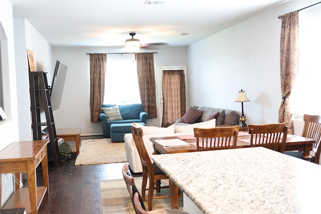 dining room featuring ceiling fan and dark wood-type flooring