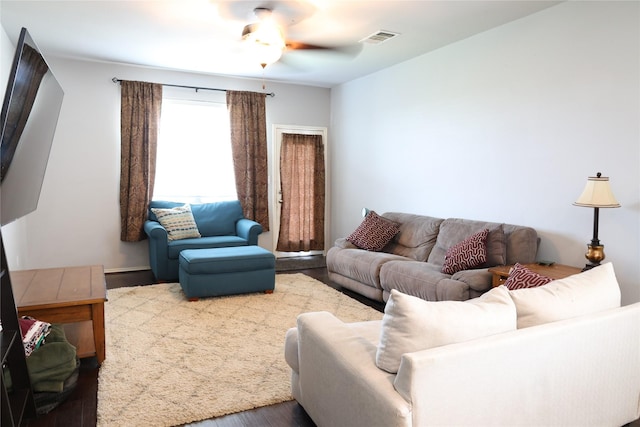 living area with ceiling fan, wood finished floors, and baseboards