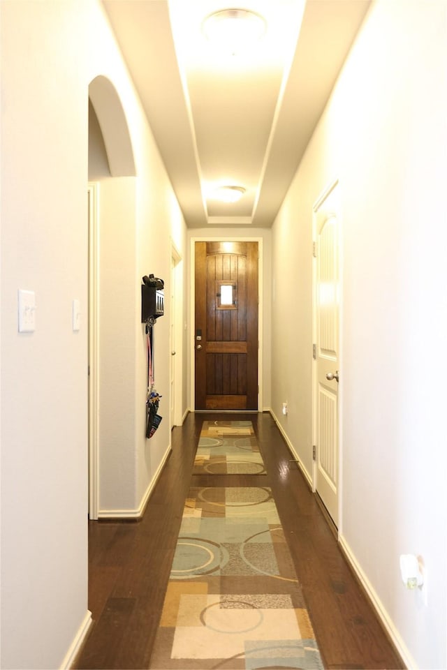 entryway featuring dark wood finished floors and baseboards