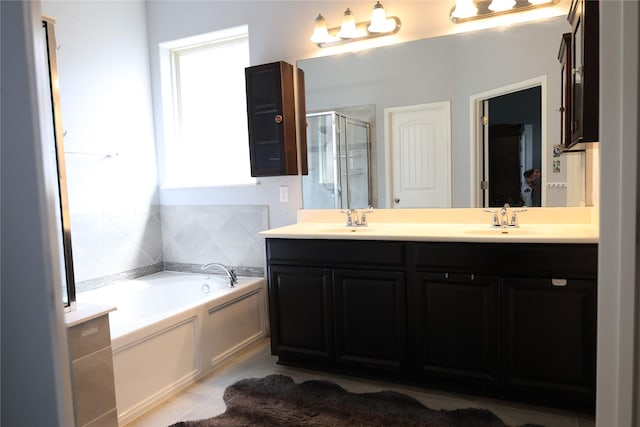 bathroom with a shower stall, a garden tub, double vanity, and tile patterned floors