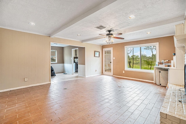 unfurnished living room with beamed ceiling, visible vents, ceiling fan, and a textured ceiling