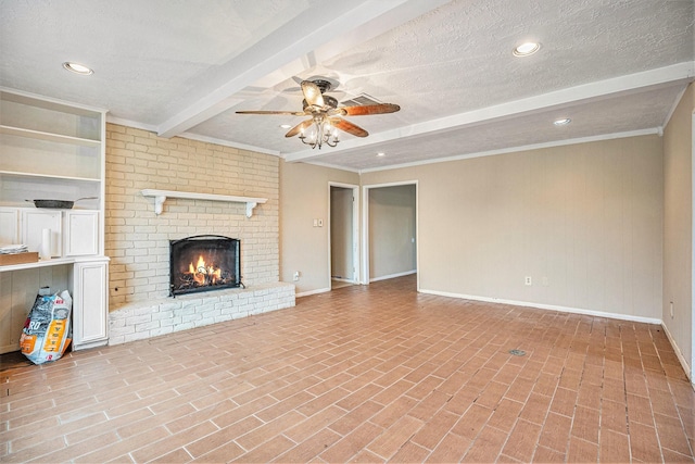unfurnished living room featuring a fireplace, a textured ceiling, baseboards, beamed ceiling, and ceiling fan