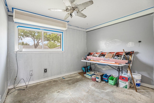 interior space with baseboards and ceiling fan