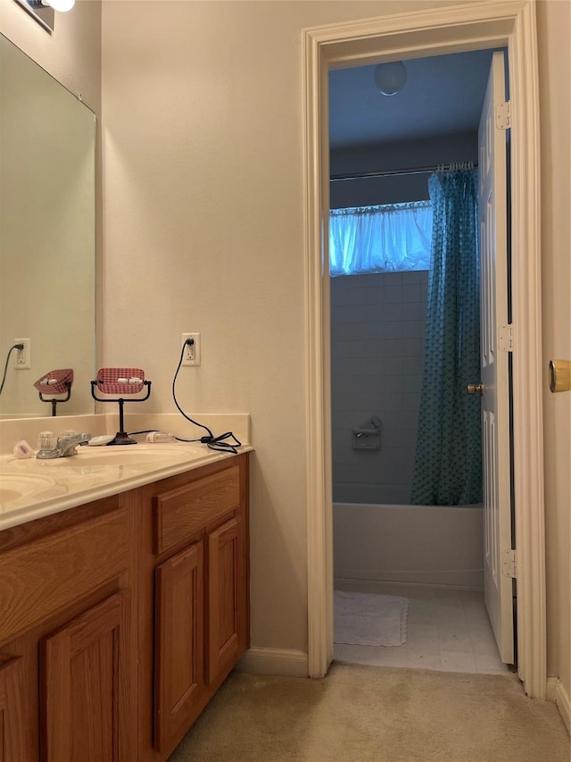 bathroom featuring shower / bath combination with curtain, vanity, and baseboards
