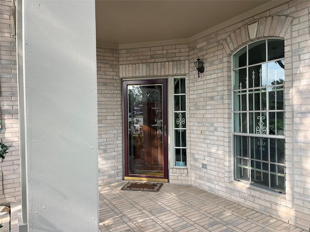property entrance with brick siding
