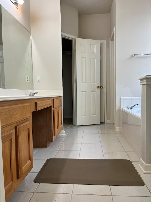 bathroom featuring a garden tub and vanity