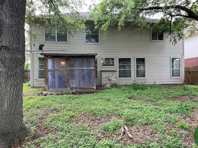 rear view of house with fence