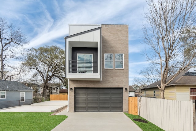 view of front of property with fence, an attached garage, a balcony, driveway, and brick siding