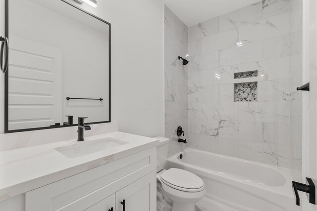 bathroom with bathtub / shower combination, toilet, and vanity