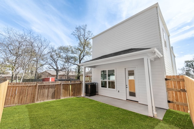 rear view of property featuring a lawn, fence, cooling unit, and a patio