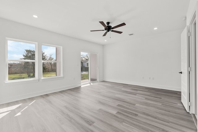 spare room featuring baseboards, light wood-type flooring, recessed lighting, and a ceiling fan