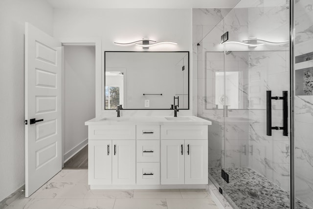 full bathroom featuring marble finish floor, a sink, a marble finish shower, and double vanity